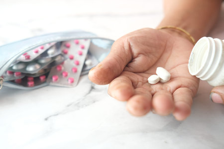 elderly women taking medicine on table