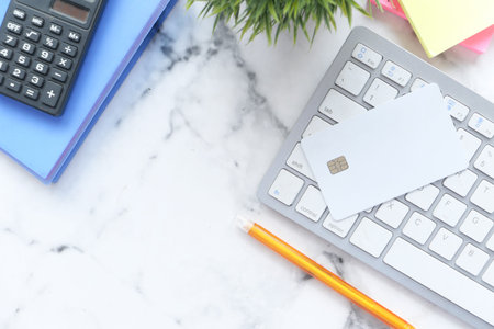 high angle view of credit cards on keyboard on white background
