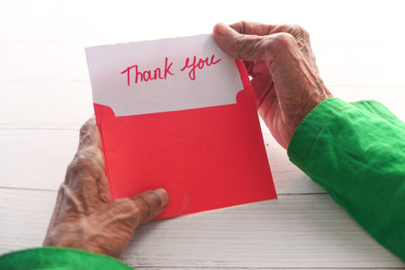 senior womens hand holding thank you letter , rear viewの写真素材