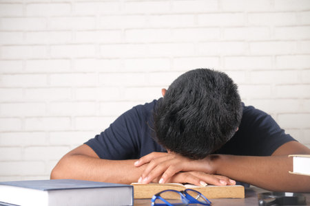 lazy young student sleeping on table