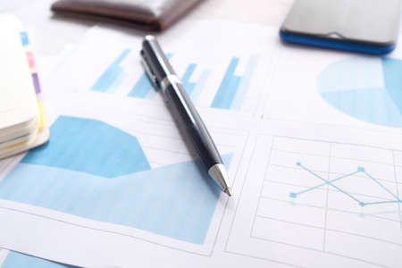 financial graph, calculator and notepad on tableの写真素材