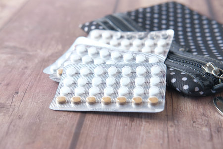 birth control pills on wooden background, close upの写真素材