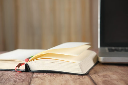 open book and a pencil on wooden table