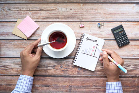 hand written growth chart on notepad at office deskの写真素材