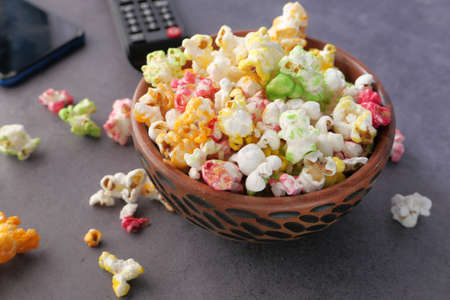 high angle view of popcorn and Tv remote on tableの写真素材