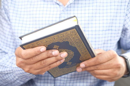 man holding Holy book Quran close upの写真素材