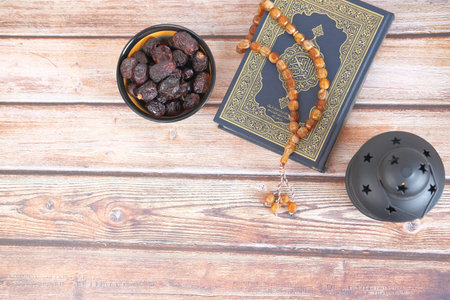 top view of date fruit , Holy book Quran and rosary on table,の写真素材
