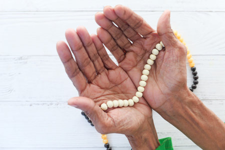 Close up of senior women hand praying at ramadanの写真素材