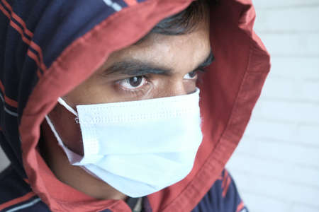 Close up of man with protective face mask looking at cameraの写真素材