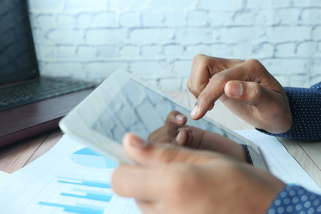 businessman using digital tablet on office desk