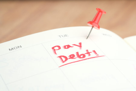 Close up of pay debt word on calendarの写真素材