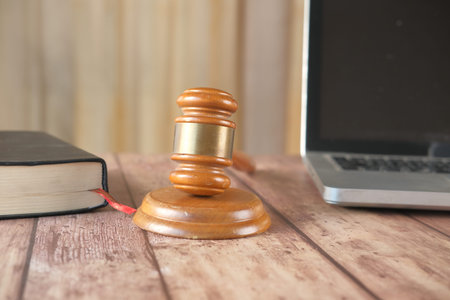 gavel laptop and book with copy space on tableの写真素材