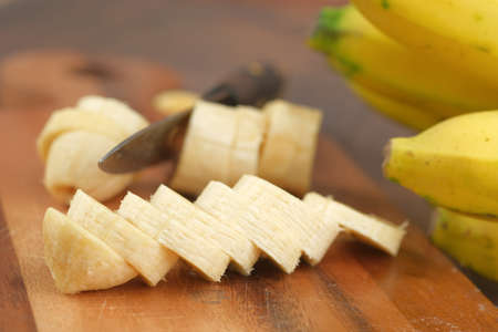 Close up of slice of banana on chopping boardの写真素材