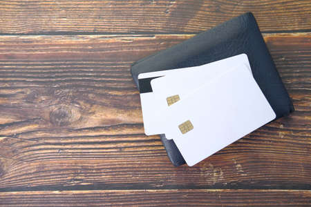 close up of credit cards on wallet on wooden backgroundの写真素材