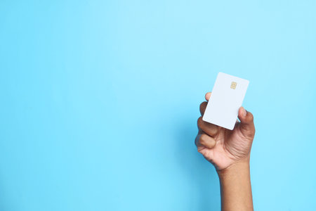 hand holding credit cards reading information