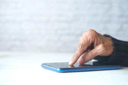 senior women hand using smart phone close up
