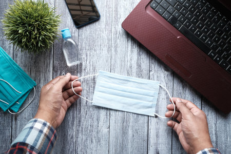 top view of blue surgical masks on office tableの写真素材