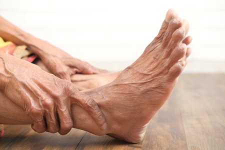Close up on senior women feet and hand massage on injury spot.の写真素材
