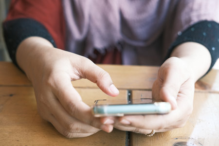 close up of women hand holding smart phoneの写真素材