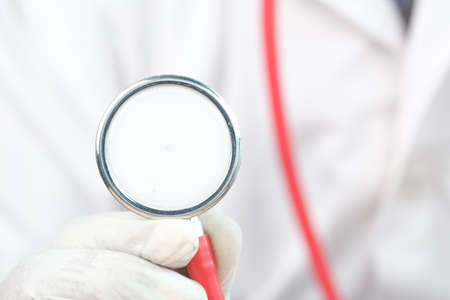 Close up of doctor hand using stethoscope.の写真素材