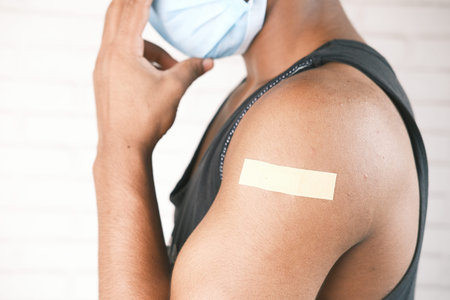 adhesive bandage on young mans arm