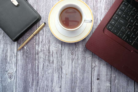 flat composition of laptop and office stationary on black deskの写真素材