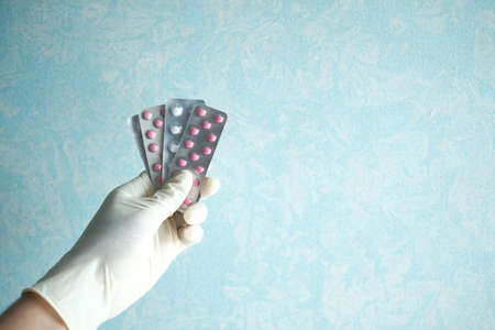 Close up of hand holding blister packs .の写真素材