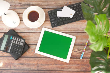 flat composition of digital tablet with empty screen and office stationaryの写真素材