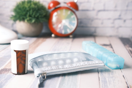 medical pill container , blister pack and pill box on home table