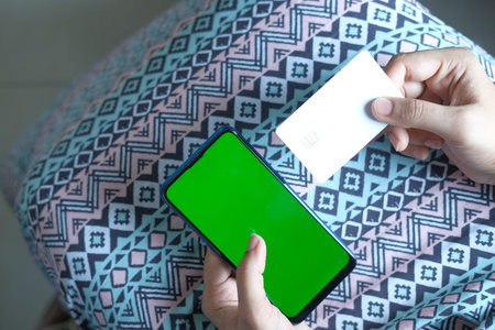 women hand holding credit card and using smart phone shopping online