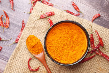 Chili powder and dried peppers on table background.の写真素材