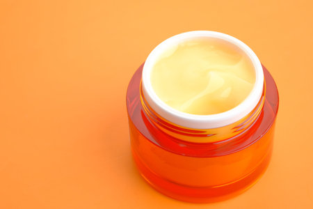 beauty cream in a container on orange backgroundの写真素材