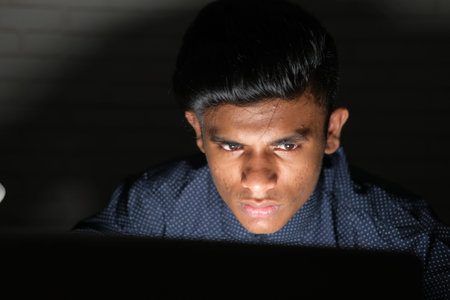 young man working on laptop stealing personal data