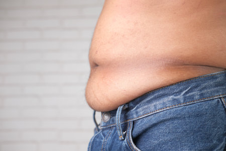 young man with excessive belly fat, overweight conceptの写真素材