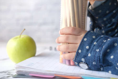 child girl holding many color pencilsの写真素材