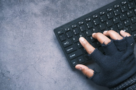 hacker hand stealing data from computer top down
