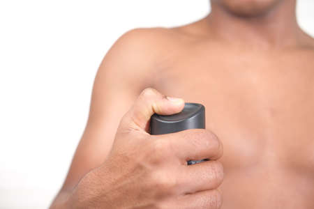 man hand holding body spray against white backgroundの写真素材