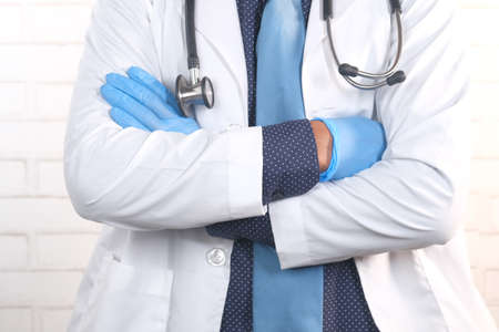 close up of doctor with arms crossed and stethoscope on neck ,の写真素材