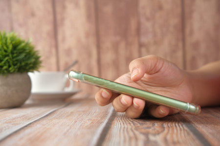 close up of women hand holding smart phone