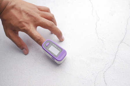 close up of man hand using pulse oximeter