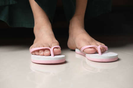 women feet in a sendal on floor matの写真素材