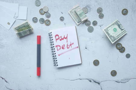 hand written pay debt word on notepadの写真素材
