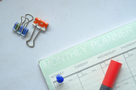 high angle view of weekly planner and notepad on table