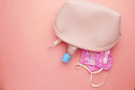 Surgical masks, thermometer and hand sanitizer in small bagの写真素材