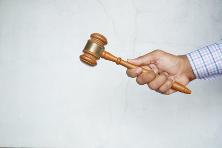 close up of persons hand striking the gavel.