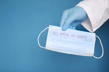 blue surgical masks on table, no mask no entry concept