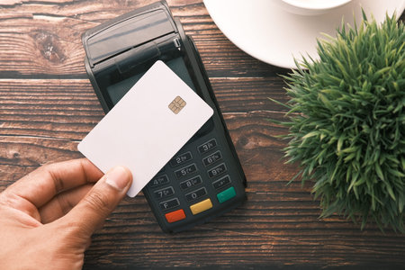 contactless payment concept with young man paying with credit card