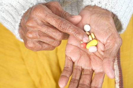close up of pills and capsule on senior womens handの写真素材