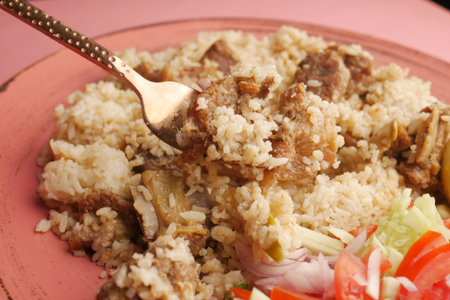 chicken biryani meal in a bowl on table.