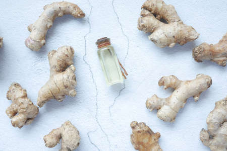 Close up of Gingers and oil in a small container on tableの写真素材